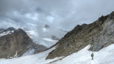 人走在冰雪覆盖山白天
